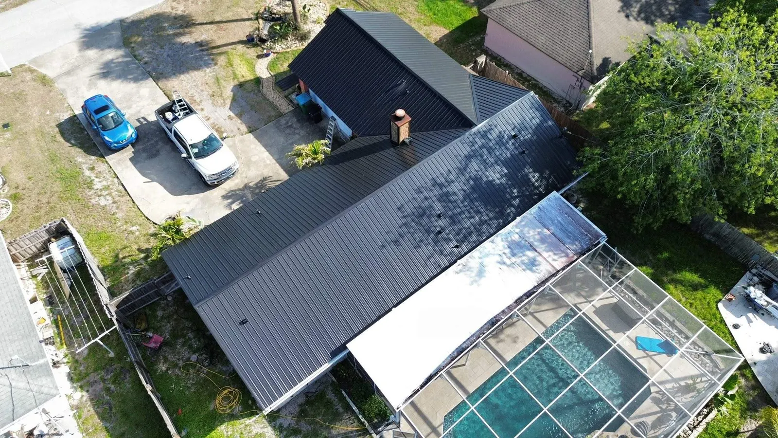 Drone view of a Deltona home with a new black rib panel metal roof