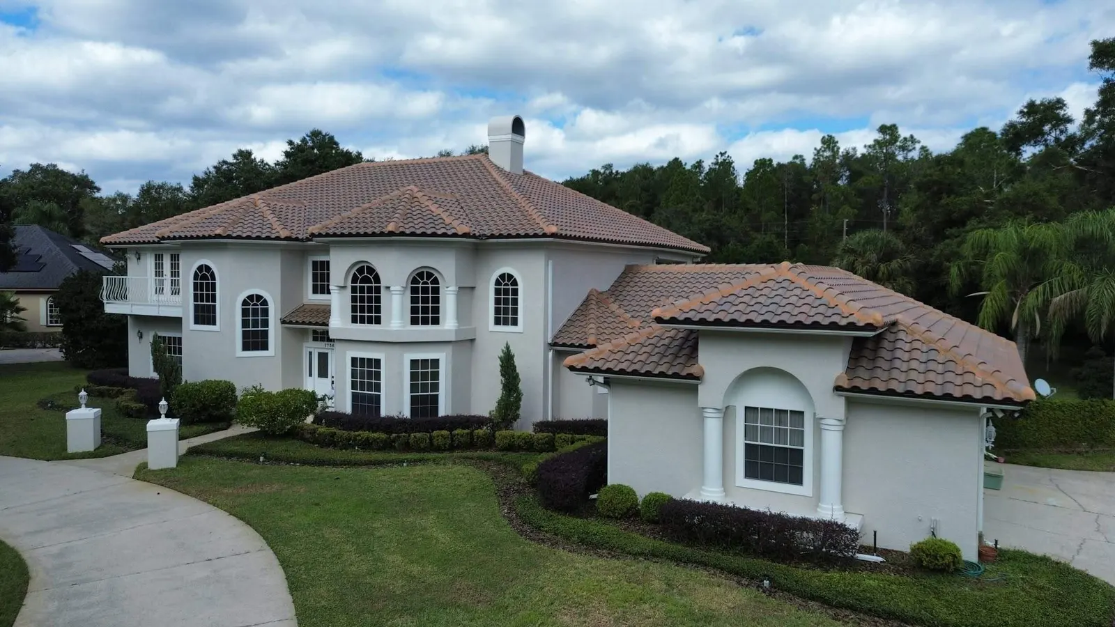 Two-story Longwood home with a concrete tile roof