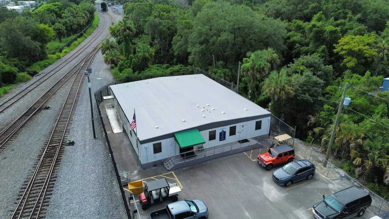 Aerial view of the Amtrak building in Sanford with its new modified bitumen roof beside the rail line
