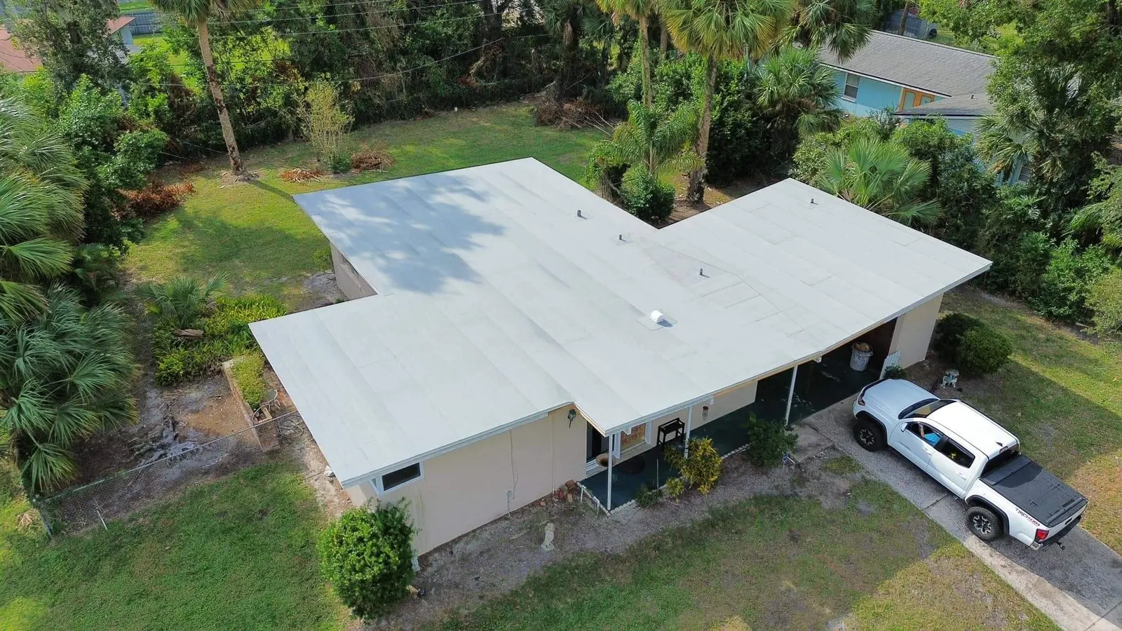 Aerial view of a Sanford home with a new white modified bitumen flat roof