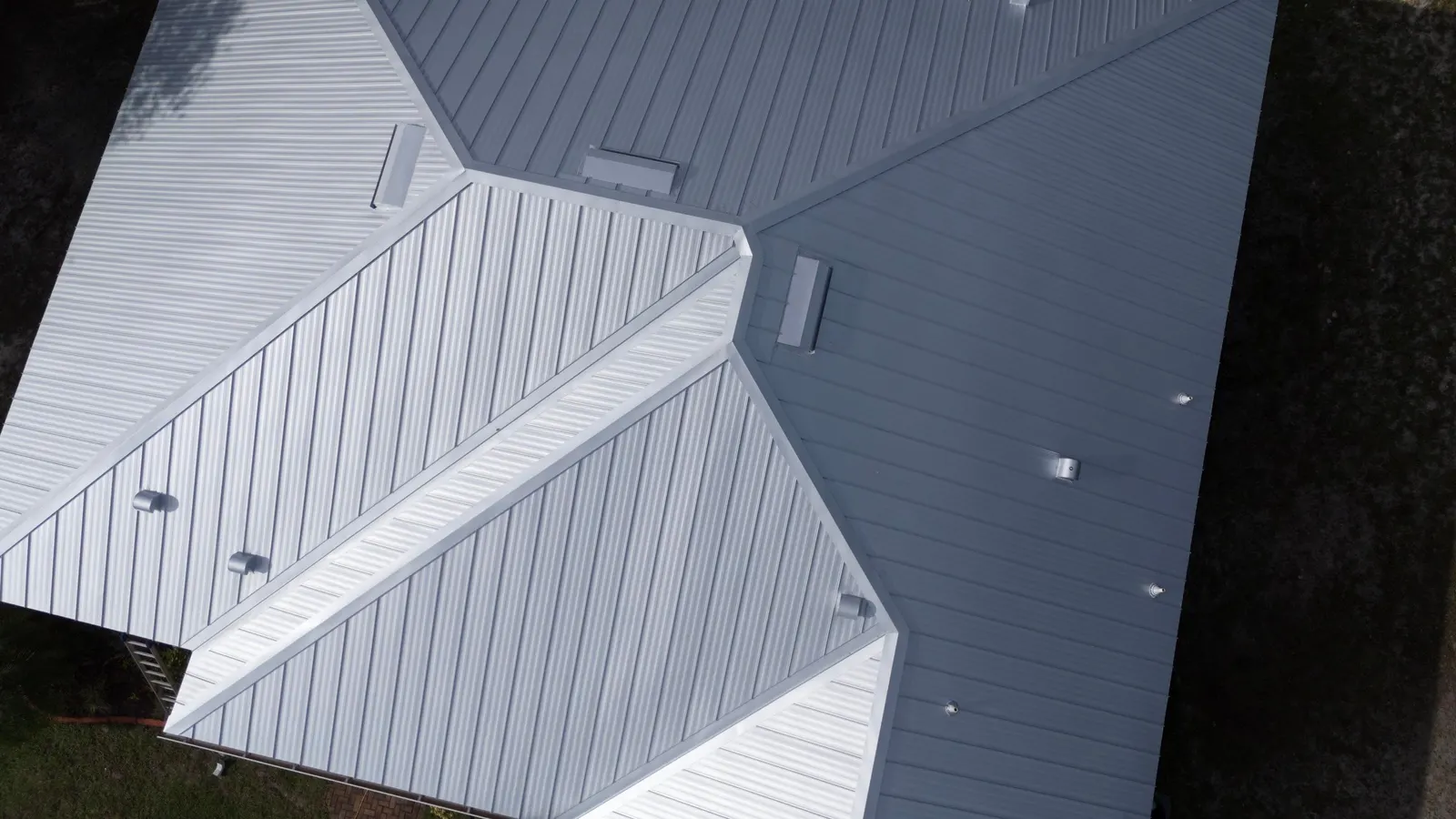 Close aerial view of the standing seam panels and hips