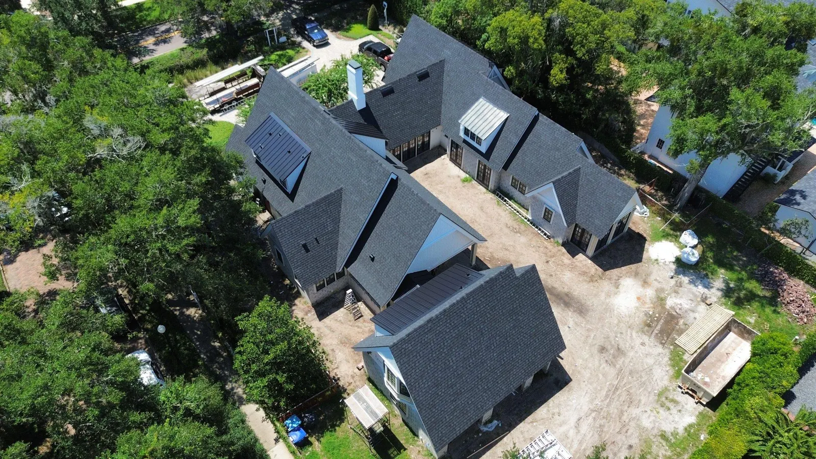 Drone view of the dark architectural shingle roof wrapping the Winter Park home's courtyard