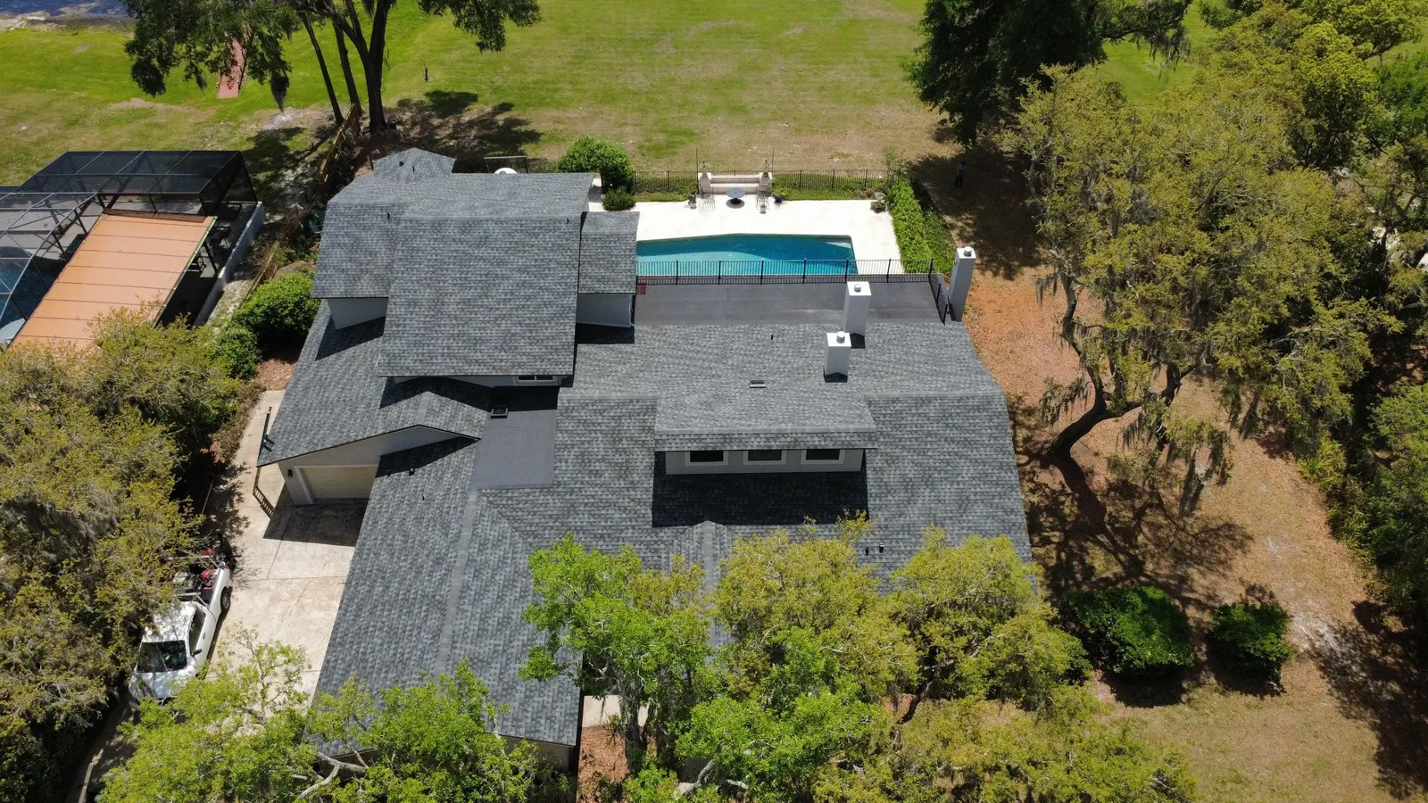 Shingle roof and flat roof sections on the Lake Mary home