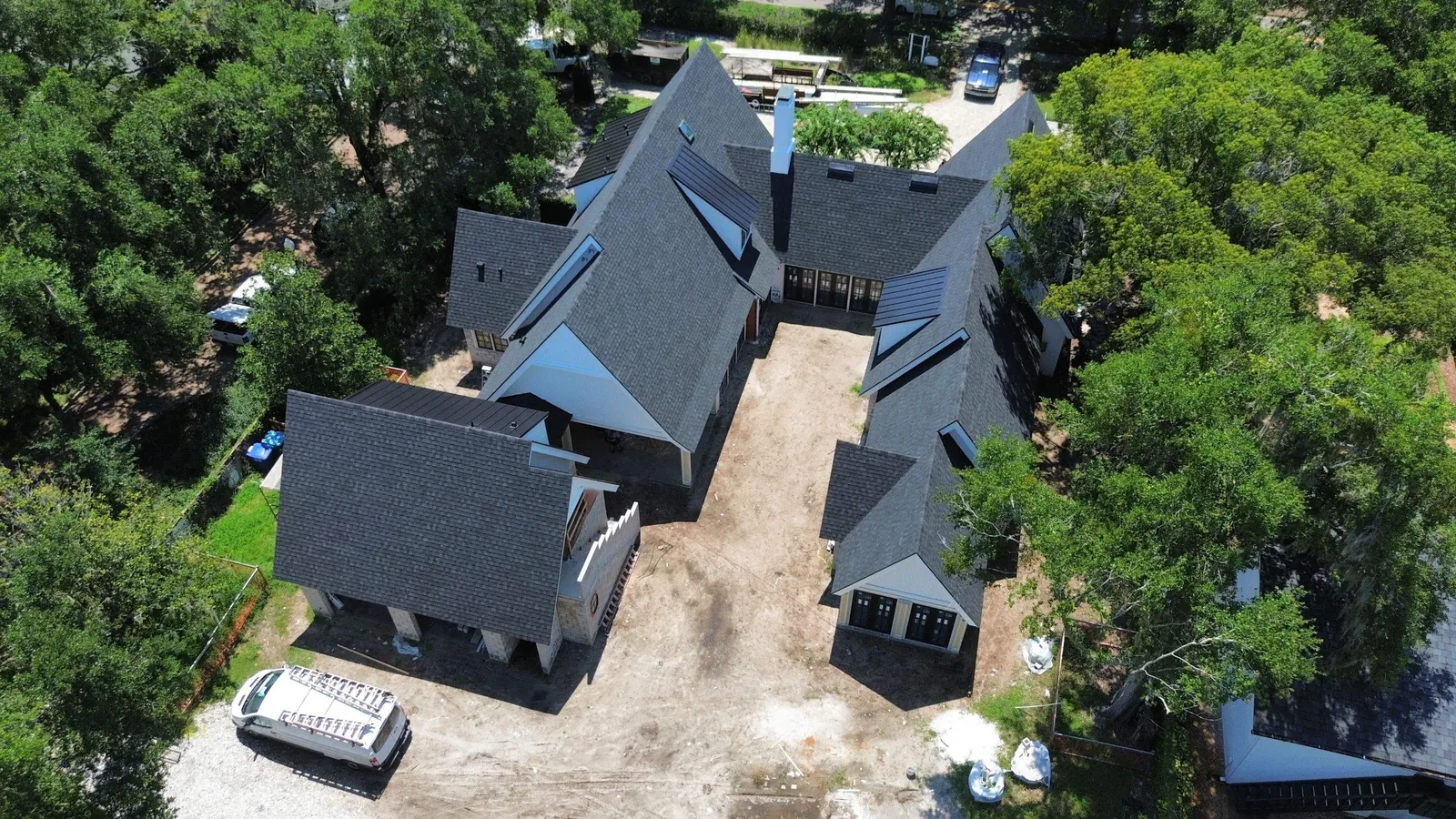 Steep-pitch shingle roof sections and dormers seen from above in Winter Park