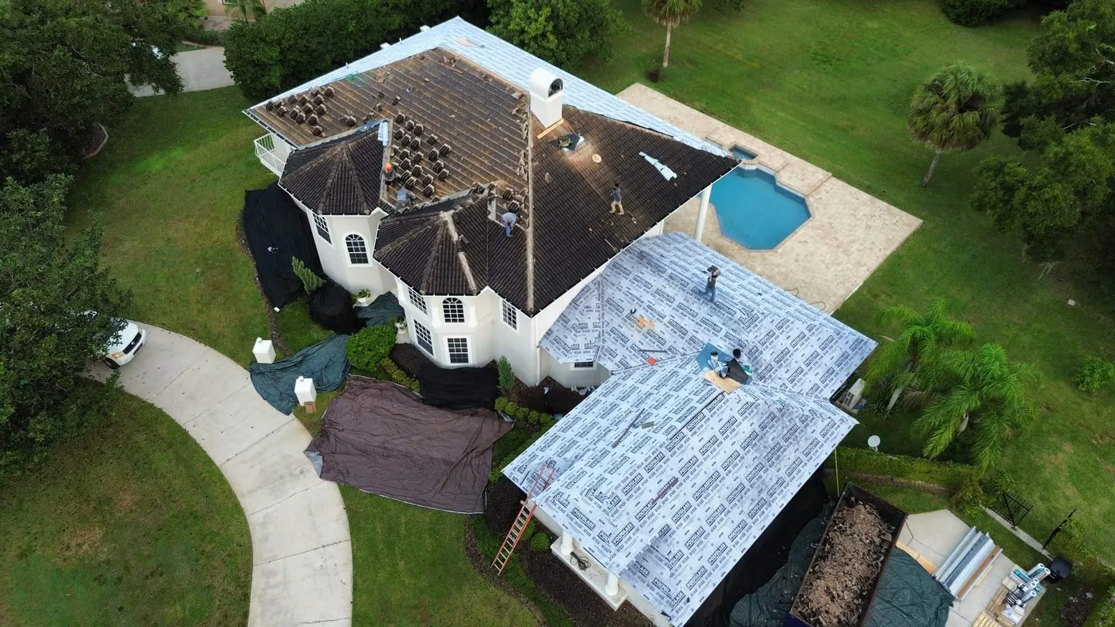 Old tile coming off as the Longwood re-roof gets underway