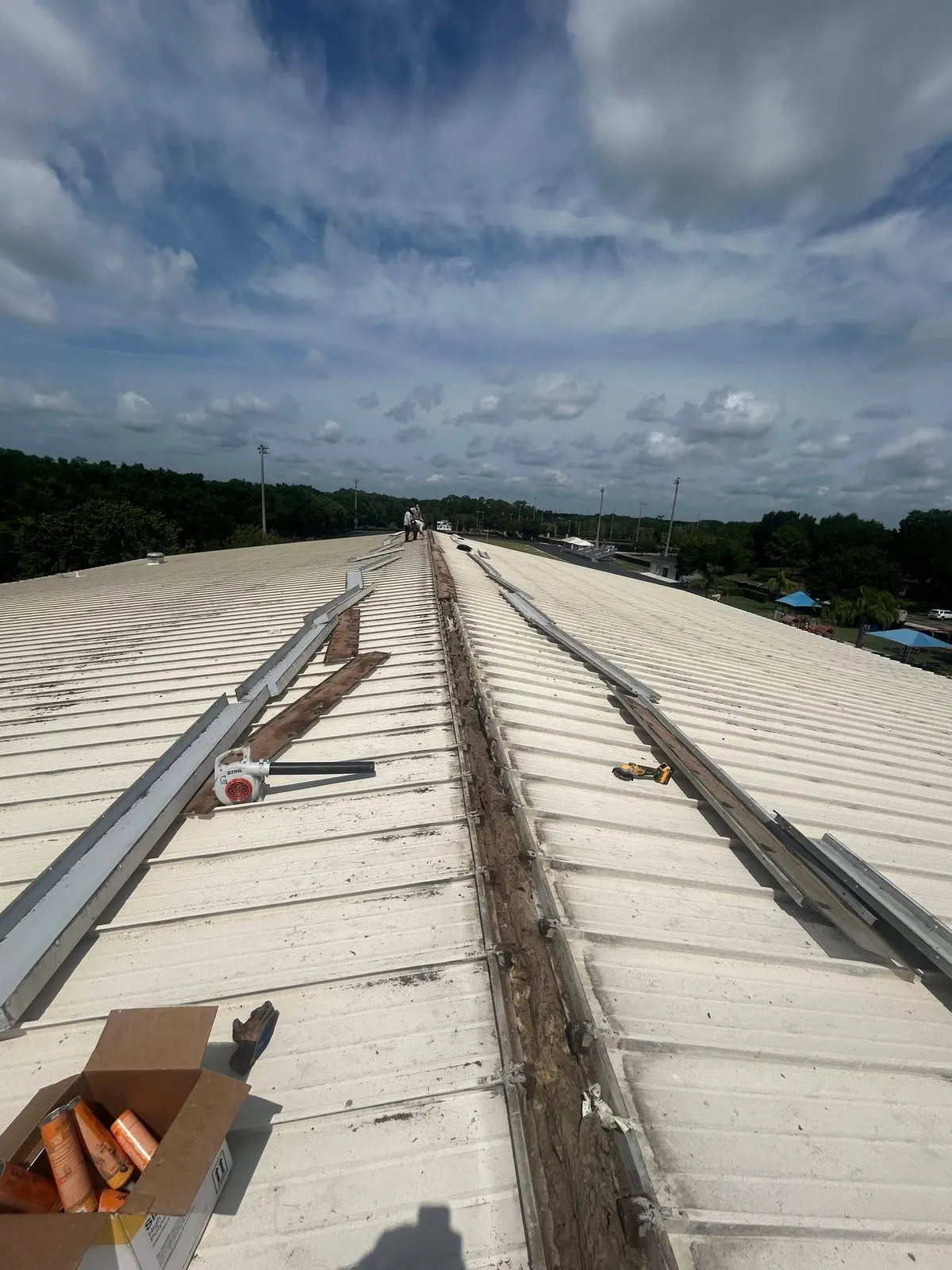 New flashing along a commercial metal building ridge