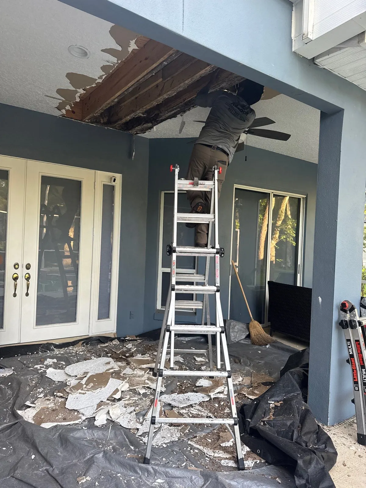 Crew opening up the damaged lanai ceiling