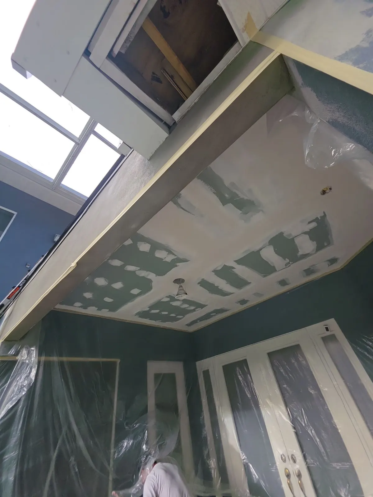 New drywall ceiling being finished after the rebuild