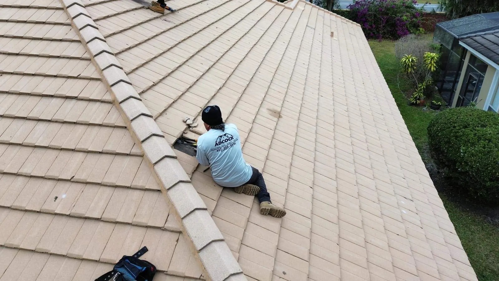 Roofer repairing a concrete tile roof