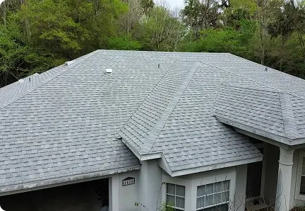Freshly installed architectural shingle roof on a stucco home