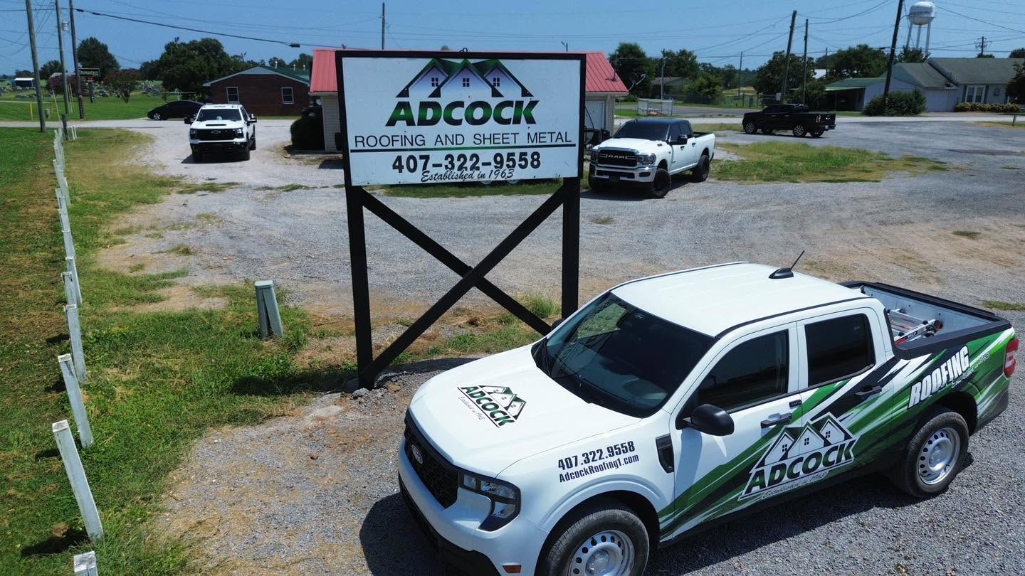Adcock Roofing sign and company truck outside the Alabama office in Hackleburg